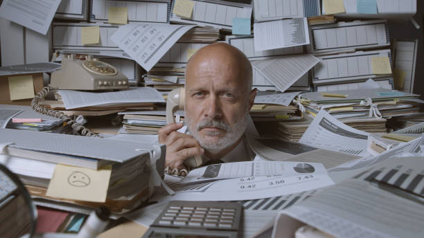 istock Stressed businessman under a lot of paperwork 1271526485