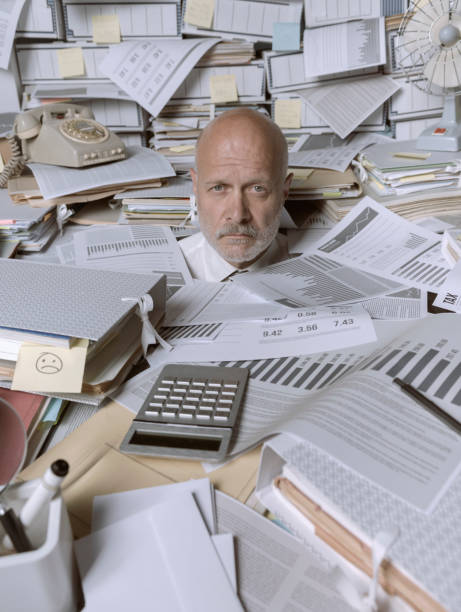 istock Disappointed stressed businessman overwhelmed by paperwork 1271527322