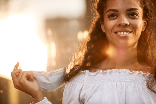 istock Taking her disposable protective face mask off and smiling 1271527395