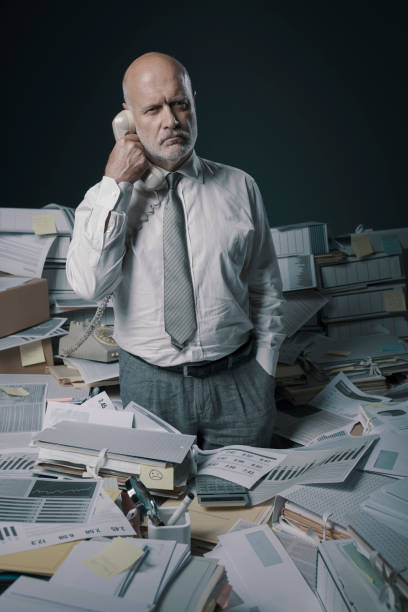 istock Confused stressed office worker answering phone calls 1271527586