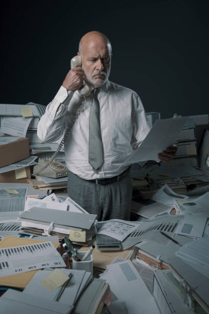 istock Confused stressed office worker answering phone calls 1271527717