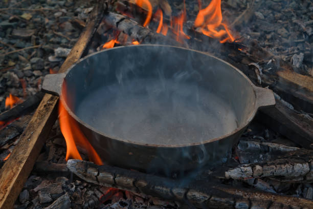 istock Empty black cast-iron frying pan on a fire close-up. 1271532305