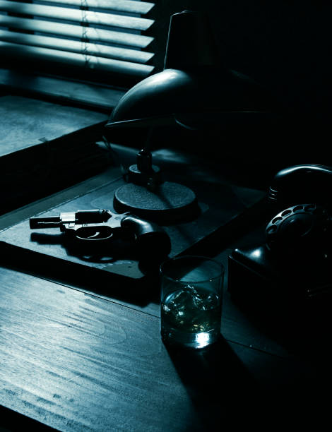 istock Film noir: detective desktop with revolver and whiskey 1271532935