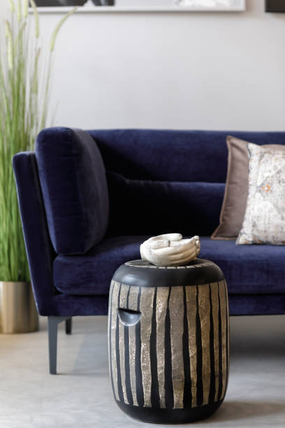 istock Stylish composition at living room interior with design ceramic stool, velvet sofa, pillows, plants, hand tray and elegant personal accessories in modern concept. Template. 1271533060