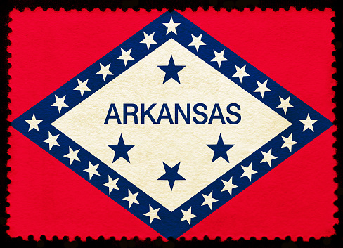 United States Arkansas  state flag on the old grunge postage stamp isolated on black background. Texture of old paper. Realistic illustration