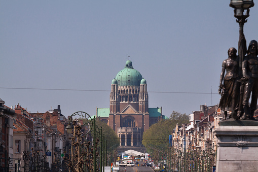 Distance shot of Koekelberg cathedral from bridge over Canal of Brussels. View along street Boulevard Leopold II
