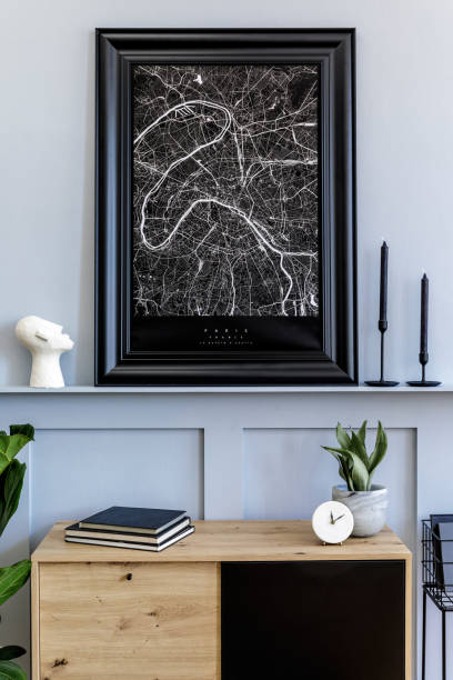 istock Modern scandinavian home interior with mock up poster frame, design wooden commode, cacti, plants, decoration, shelf, candlestick, book and personal accessories in stylish home decor. 1271534795