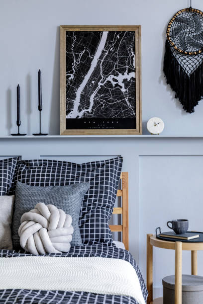 istock Stylish scandinavian bedroom interior with design coffee table, mock up picture frames, book, decoration, personal accessories, beautiful bed sheets, blanket and pillows. 1271534850