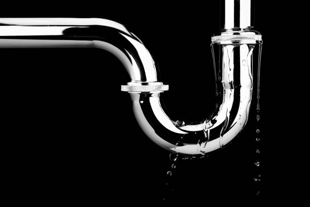 Leaking of water from stainless steel sink pipe on isolated on black background Leaking of water from stainless steel sink pipe on isolated on black background faucet leaking pipe water stock pictures, royalty-free photos & images