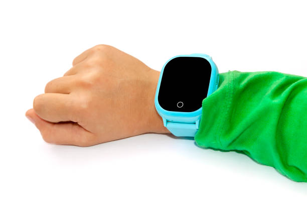 istock Blue smart digital watch on boy hand with green sleeve. Modern children technologies. GPS tracker for kids, child tracking and parental control concept. 1271535467