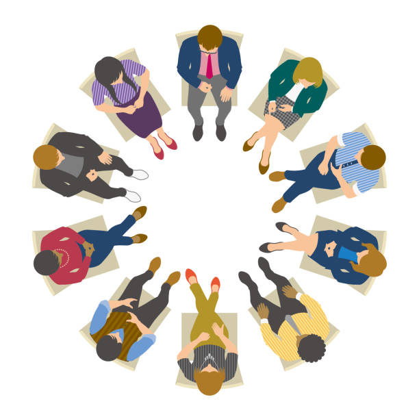 High angle view of business people sitting in circle and having meeting Group of creative business people sitting on chairs and talking viewed from directly above. chair illustrations stock illustrations