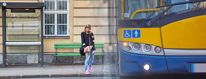 Young caucasian woman waiting for a public transportation on a station.