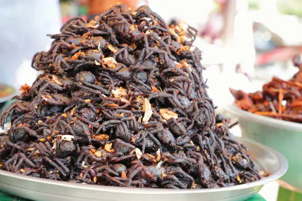 Photo of Plate of cooked spiders sold in a Cambogian street market