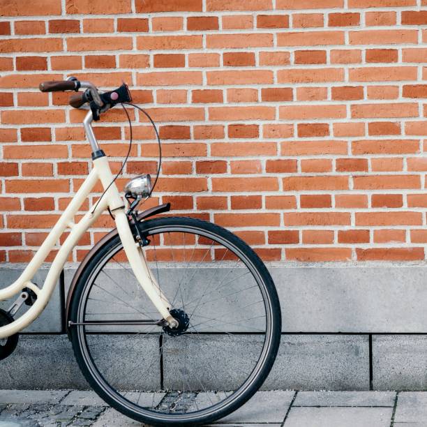 istock Vintage bicycle on the brick wall background 1271541056