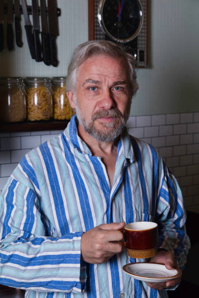 istock Middle aged man wearing striped pajamas 1271541956