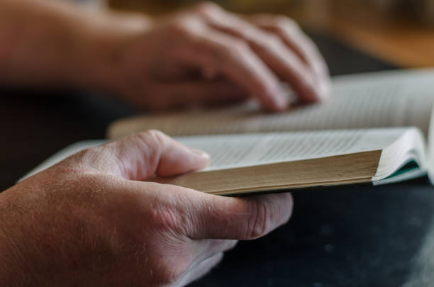 istock Male hands are holding an open book. 1271542329