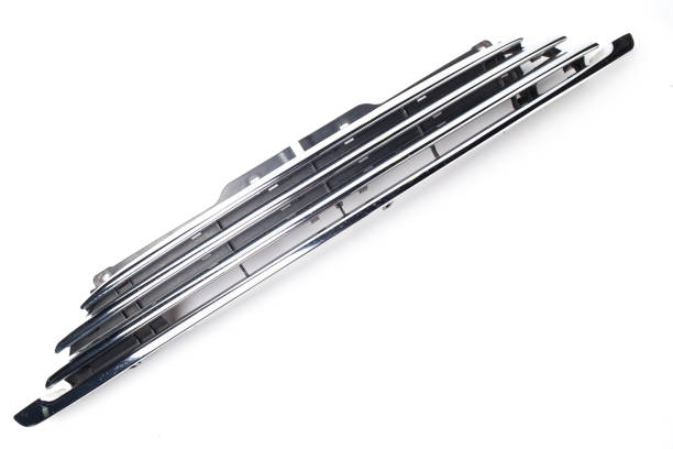 Radiator grille on white background in shiny chrome metal in photo studio is an element of car body that protects and allows air to enter the engine. Tuning detail on auto parsing for sale or catalog. rejilla del radiador sobre fondo blanco en metal cromado brillante en estudio fotográfico es un o de la carrocería del coche que protege y permite que el aire entre en el motor. detalle de ajuste en el análisis automático para la venta o el cat�