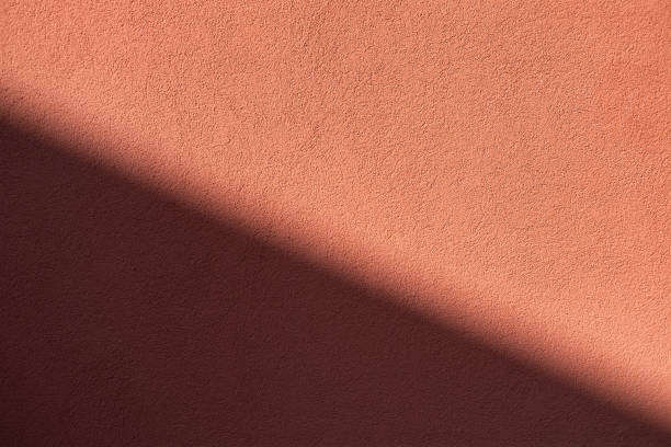 istock Light and shadow on the wall. Idea for design. Wall as a background for concept and idea.  Lush lava color. 1271545310