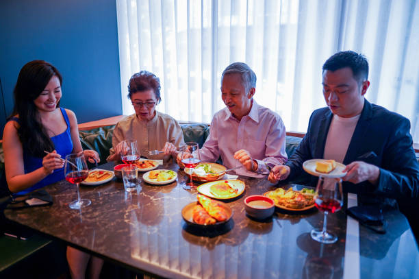 istock Multi-generation Asian Family eating together at a restaurant. 1271546100
