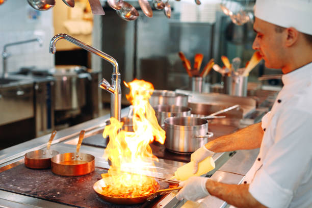 istock Chef cooking vegetables in wok pan. Shallow dof. 1271546855