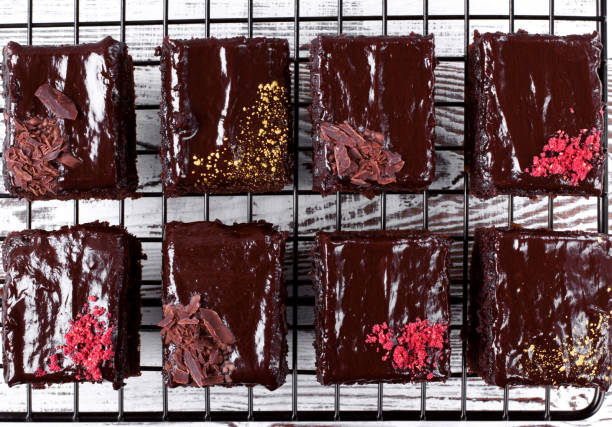 Set of brownie cakes with ganache and assorted toppings