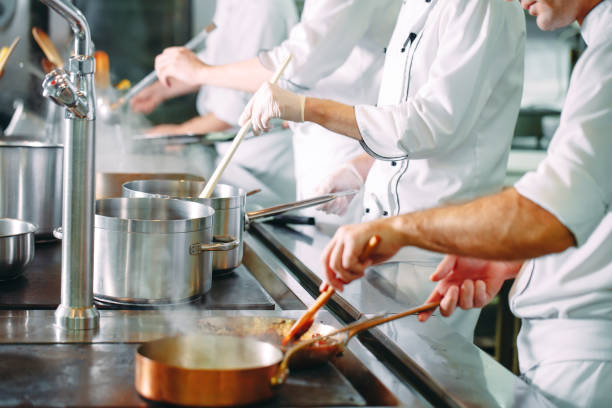 istock Chef cooking vegetables in wok pan. Shallow dof. 1271547630