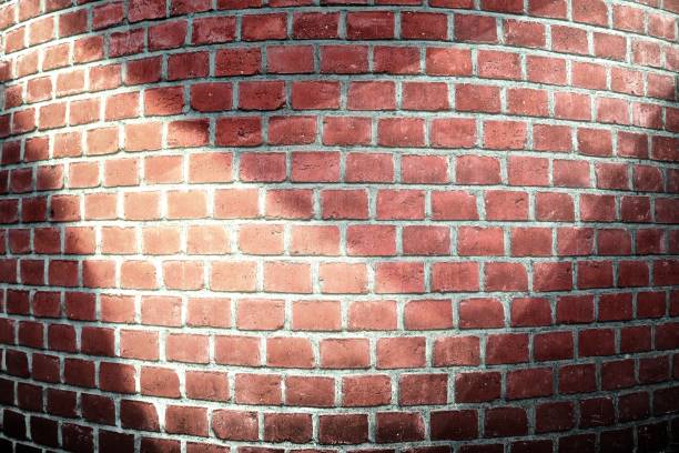 istock Aged and weathered brick wall textures with very bright spotlight illumination 1271547752