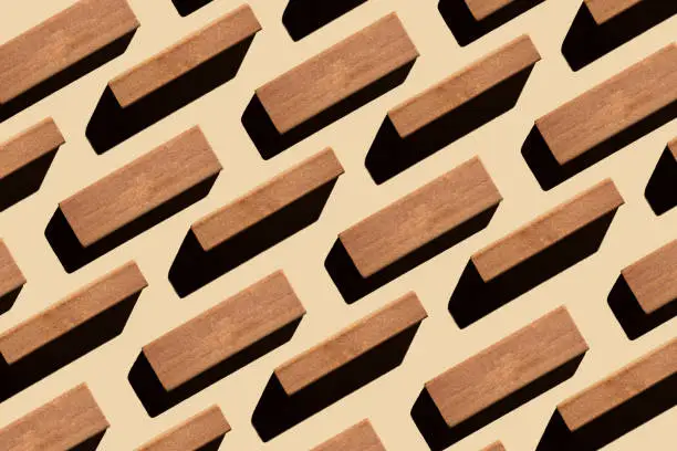 Pattern of small rectangular wooden blocks on beige background. sustainable lifestyle and biophilic design concept. Zero waste, plastic free, sustainable, minimalism.