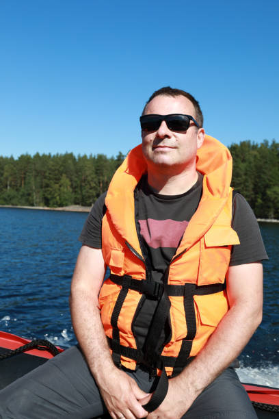 istock Man posing in life jacket on boat 1271549573