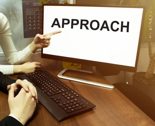 istock male and female hand, computer with text APPROACH with office background 1271550510