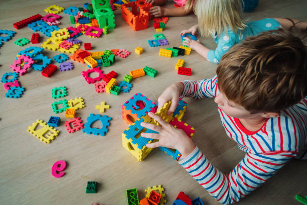 istock kids playing with puzzle, education concept, learning through play 1271550558