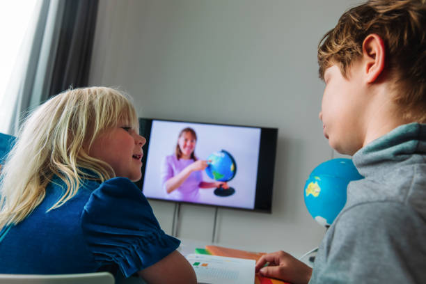 istock Kids learning remotely. Children having online lesson at home 1271550734
