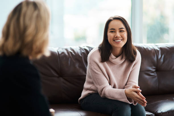 A problem shared is a problem halved Shot of a young woman having a therapeutic session with a psychologist psychotherapy stock pictures, royalty-free photos & images