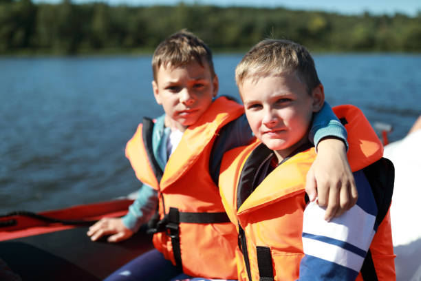istock Two children in life jacket on boat 1271550888