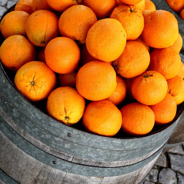 wooden barrel full of oranges