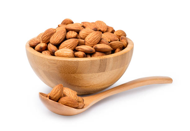 istock Fresh almonds nut in wooden bowl with spoon isolated on white background  with clipping path. 1271552371