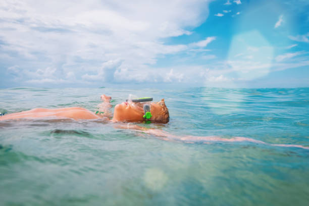 istock kid floating at sea vacation, boy enjoy summer 1271552726