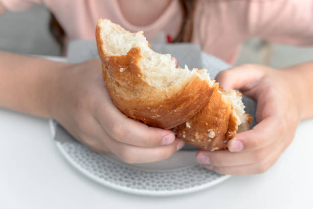 istock Young girl eat croissant 1271553548