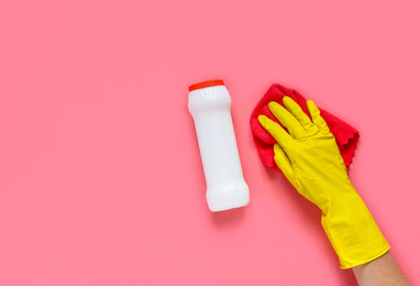 istock Woman's hand cleaning on a pink background.Cleaning or housekeeping concept background. Copy space. Flat lay, Top view. 1271553789