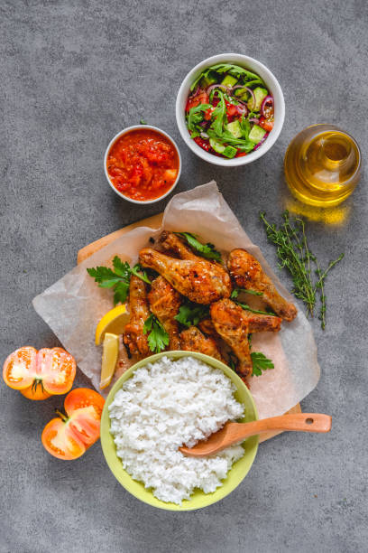 istock Baked chicken legs with rice and salad. 1271554103