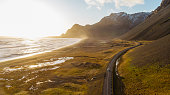 Aerial view of a car driving on scenic road in Iceland