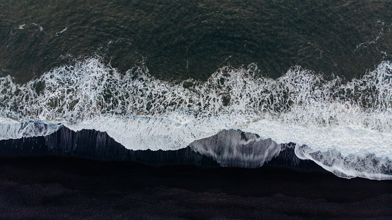 Aerial view of a black sand beach in winter Iceland