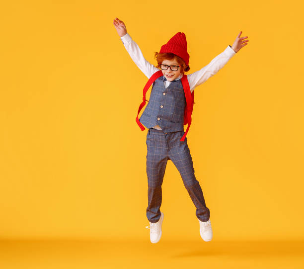 istock Energetic stylish schoolboy leaping up 1271555384