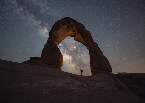 Milky Way Galaxy and a shooting star with Delicate Arch in Arches National Park Utah