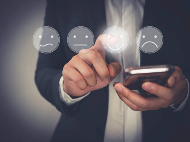 istock Customer Experience Concept, Business people holding the smartphone with a checked box on Excellent Face and Rating for a satisfaction survey. 1271555974
