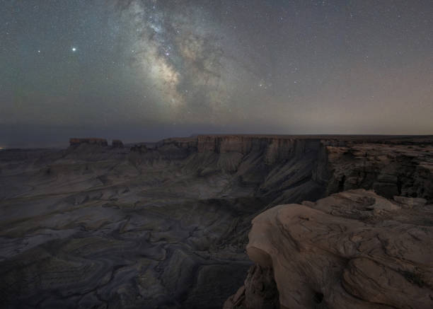 istock Cliff edge overlooking a canyon and the Milky Way Galaxy at Skyline View 1271557306