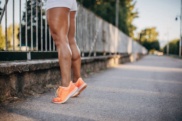 One young athletic woman training outdoors in the city. Fitness outdoors concept.