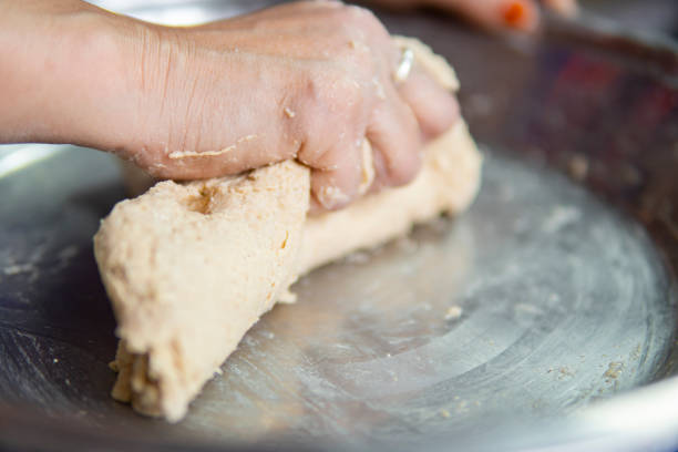 istock Close-up of hands kneading wheat dough. 1271558639