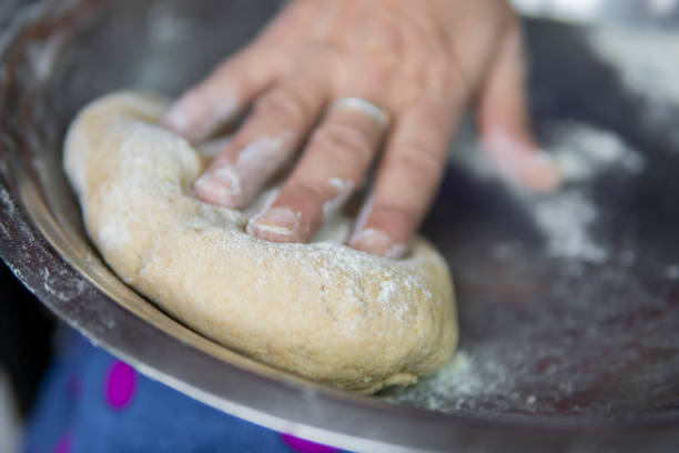istock Close-up of hands kneading wheat dough. 1271558656