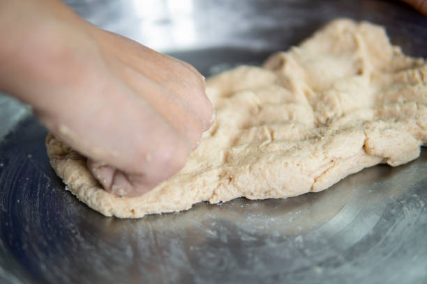 istock Close-up of hands kneading wheat dough. 1271558718